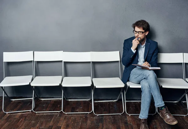 Man sitting on a chair waiting for job interview work lifestyle emotions