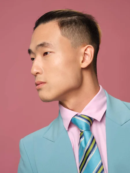 Asian male man fashionable hairstyle self confidence blue jacket pink background