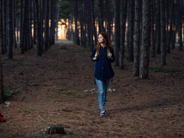 Woman hiker walk in the forest near pine trees in nature — Stock Photo, Image