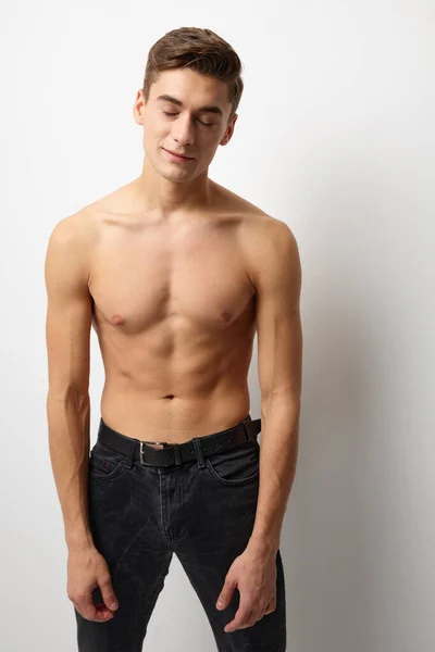Male naked muscled body black pants studio posing cuteness — Stock Photo, Image