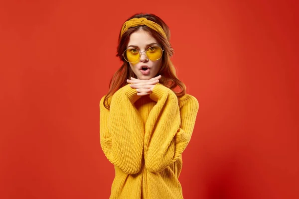 attractive woman in yellow sweater fashion hairstyle attractive look red background
