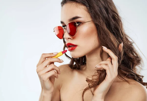 Woman in sunglasses with red lipstick cropped view