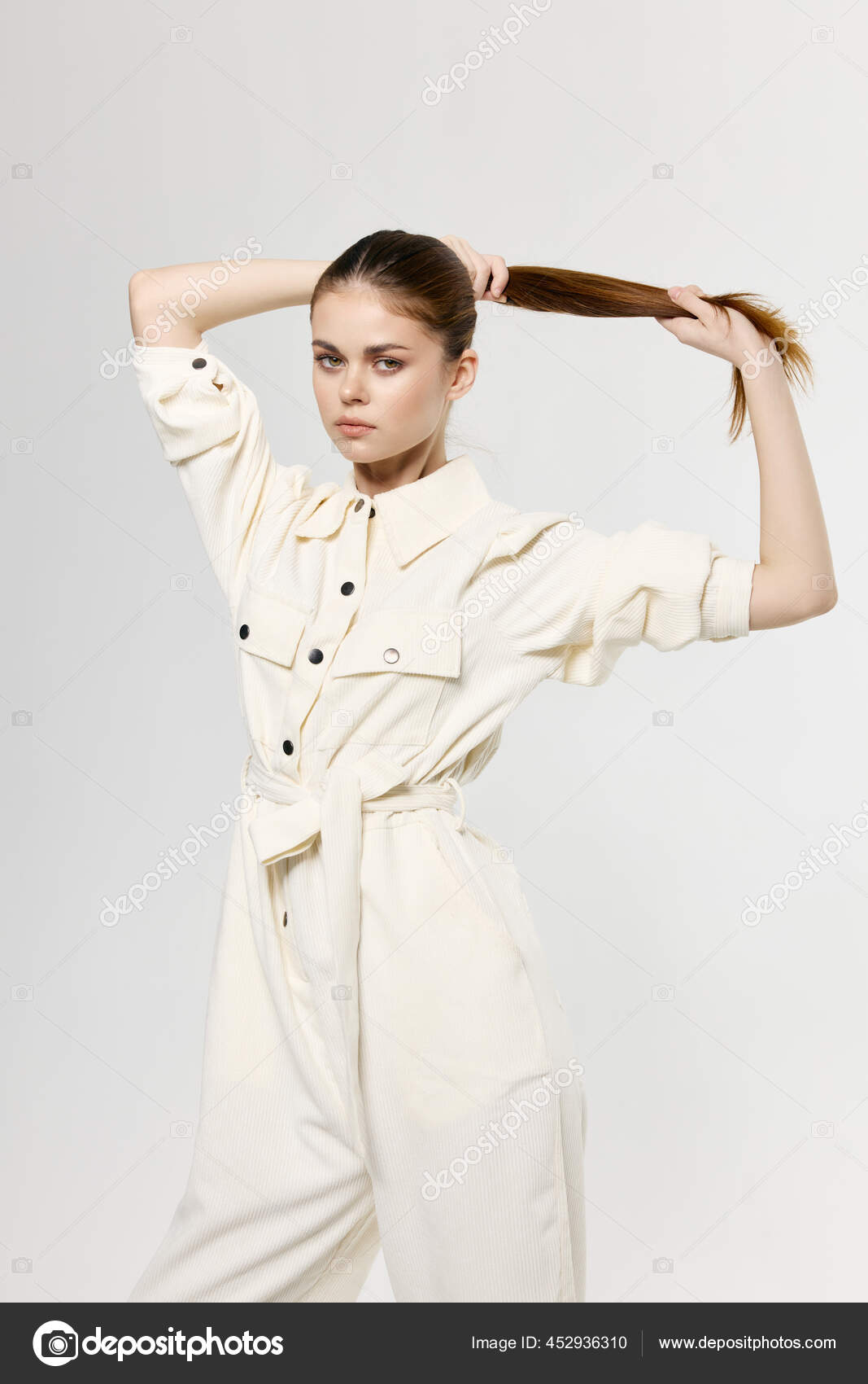 Fashionable girl with makeup and hairstyle in a stylish purple jumpsuit on  the background of a wooden wall. Stock Photo | Adobe Stock