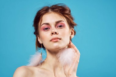 Güzel bir kadın, göz kamaştırıcı çıplak omuzlar, lüks, yakın plan mavi küpeler.