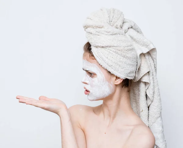 Funny woman with towel on head bare shoulders white mask on face — Stock Photo, Image