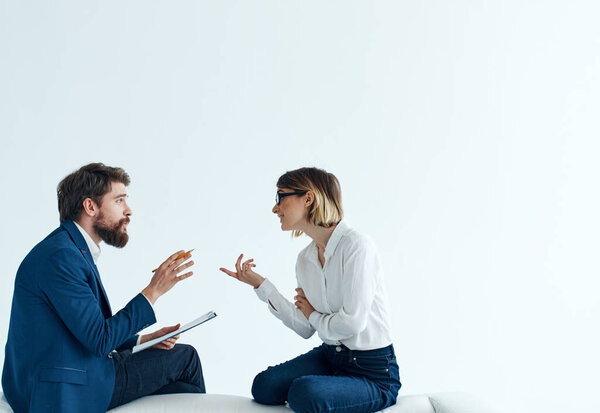 Business men and women sit on the couch communicating employees 