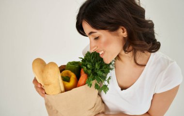 Beyaz tişörtlü esmer sağlıklı yiyecekler yiyor.