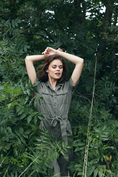 woman in forest Folded arms over head jumpsuit nature