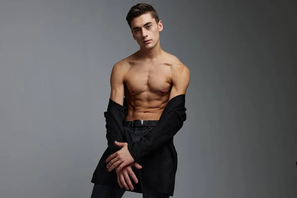 Cute man black jacket nude torso posing self-confidence