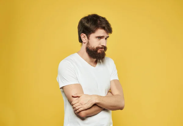 Retrato de un hombre en una camiseta blanca vista recortada fondo amarillo desconcertado look modelo —  Fotos de Stock