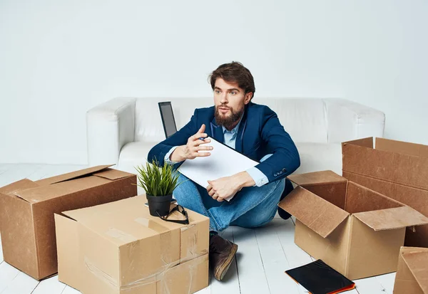 Business man documents boxes with things unpacking office manager