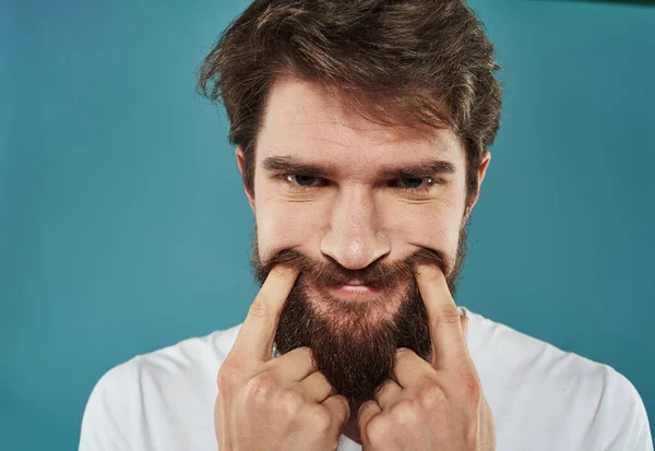 The sad man touches his face with his fingers not a real smile — Stock Photo, Image