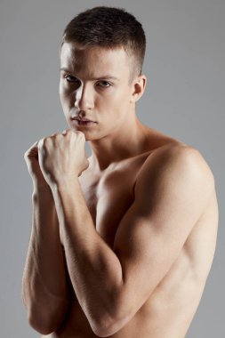 Şişirilmiş kol kaslı boksör kasları kaslı spor fitness gri arka plan kırpılmış görünüm