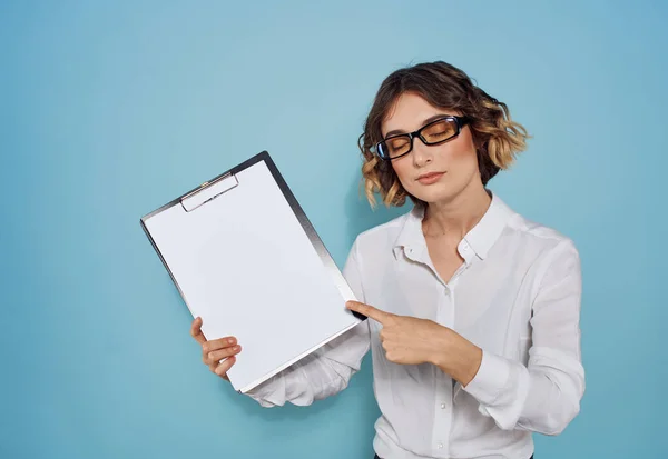 Femme d'affaires dans un costume et des lunettes avec un dossier de documents dans ses mains et une feuille blanche de maquette en papier — Photo