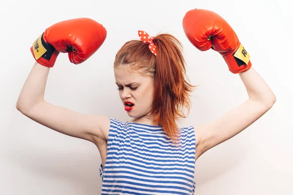 emotional woman in boxing gloves red lips striped jersey workout