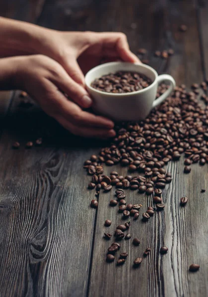 Taza y platillo granos de café sobre un aroma de fondo de madera — Foto de Stock