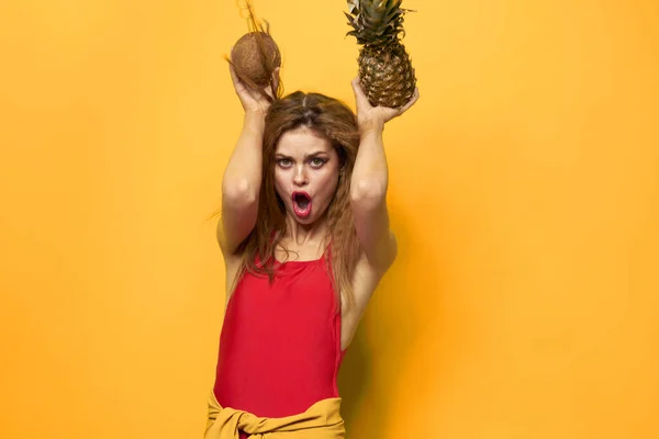 Mulher com abacaxi e coco coquetel frutas exóticas verão estilo de vida fundo amarelo — Fotografia de Stock