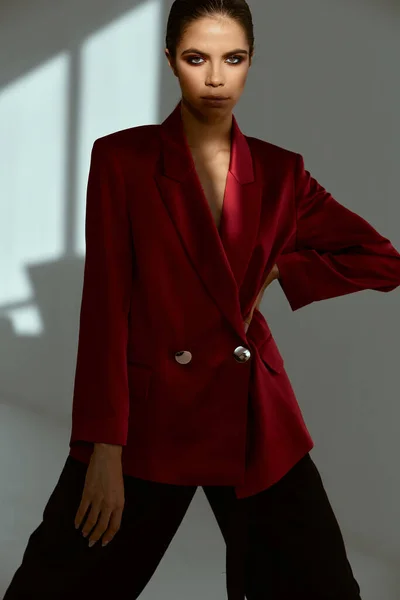 Pretty woman in red blazer studio fashion cropped view — Photo