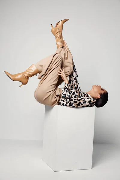 Woman upside down leopard shirt cosmetics glamor — ストック写真