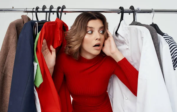 Woman chooses clothes in a fashionable store and wardrobe style