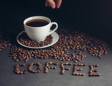 Kahvaltıda bir fincan kahve ve masada yazılı Arabika içkisi.