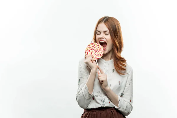 Cute red-haired woman with lollipop in her hands fun and sweets emotions — Stock Photo, Image