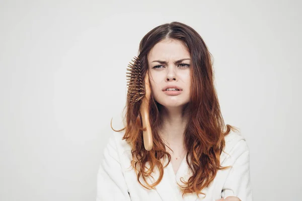 woman combing hair health problems white coat