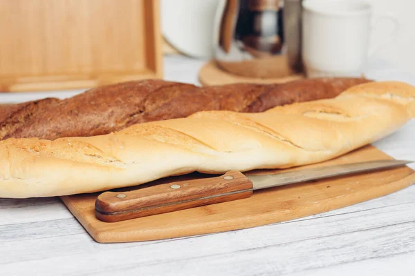 Chleb na drewnianym stole nóż kuchenny do pieczenia śniadania — Zdjęcie stockowe