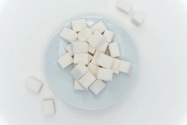 Refined sugar cubes on a plate energy calories — Stock Photo, Image