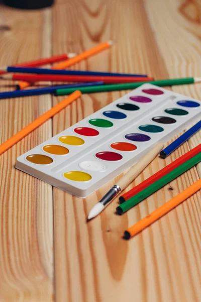 Stationery colored pencils paint wooden table art — Stock Photo, Image