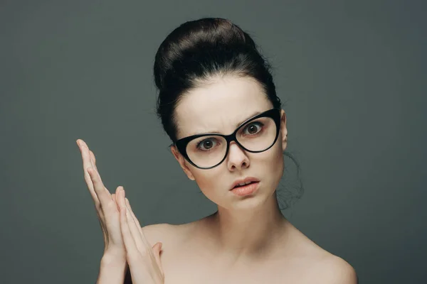 Woman with bare shoulders wearing glasses gathered hair charm — Stock Photo, Image