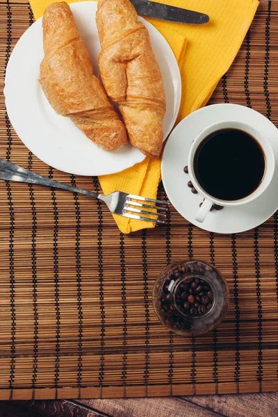 Φρέσκα κρουασάν σε ένα πιάτο στο επιδόρπιο πρωινό τραπέζι — Φωτογραφία Αρχείου