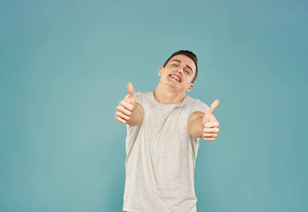 Handsome man t shirt emotions hand gestures blue background — Stock Photo, Image