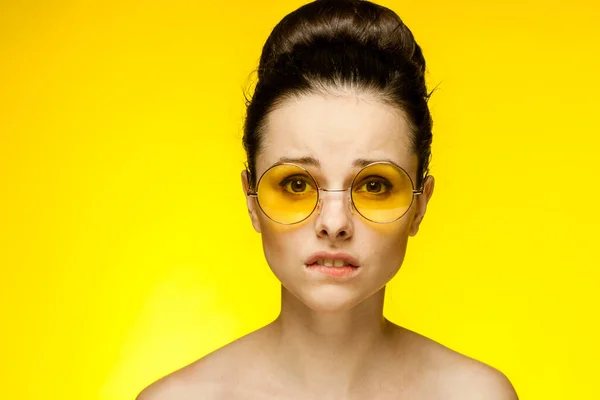 Çekici bir kadın çıplak omuzlar sarı gözlükler moda cazibesi — Stok fotoğraf