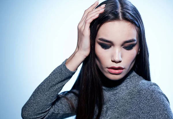 Beautiful makeup eyeshadows on the eyelids And pink lips of a brunette woman on a light background Stock Picture