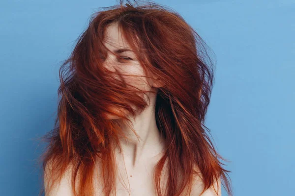 Mulher feliz com cabelo vermelho no fundo azul diversão emoções tousled cachos — Fotografia de Stock