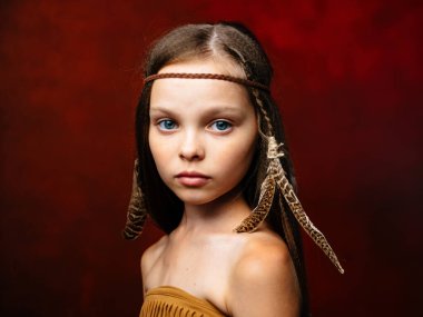 Kırmızı arka planda, tüylü bir Aborjinin kafasında süs olan kız vahşidir.