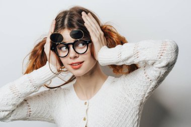 Kafasını tutan gözlüklü neşeli, güzel bir kadın...