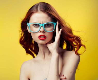 Sarı arka planda mavi gözlüklü kadın portresi