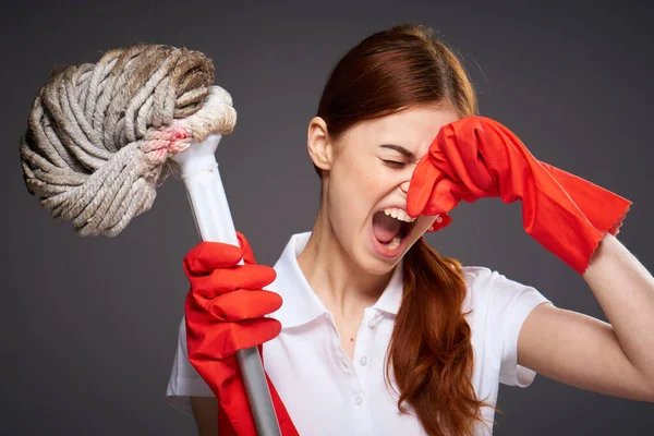 Cleaning lady covers her nose with her fingers unpleasant smell mop in hand cleaning discontent — Stock Photo, Image