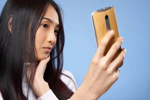 Frau asiatischen Aussehens mit Telefon in der Hand kommuniziert Internet-Lifestyle-Technologie — Stockfoto