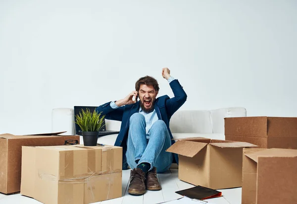 Man in a suit boxes with things moving office professional unpacking