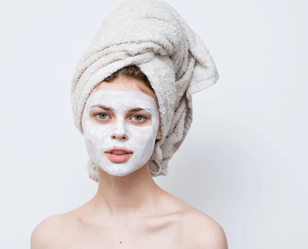 Pretty woman with towel on head emotions naked shoulders and mask on face — Stock Photo, Image