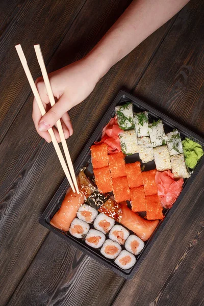 Set sushi rolls delicacy wooden sticks top view japanese cuisine — Stock Photo, Image