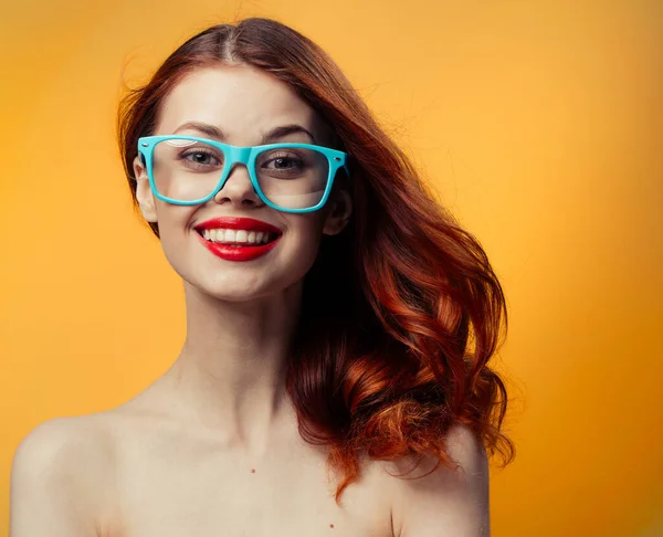 Attractive woman with bare shoulders blue glasses red hair cropped view — Stock Photo, Image