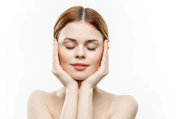 Attractive woman holding face closed eyes charm naked shoulders — Stock Photo, Image