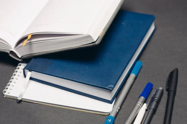 notepads documents books pens desktop gray background office