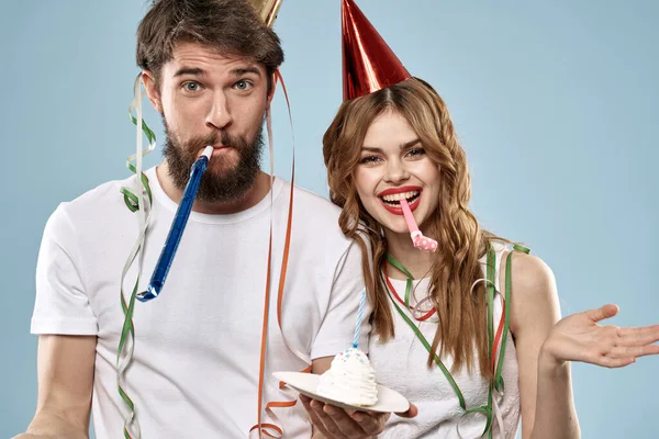 Cheerful young couple holiday birthday fun blue background
