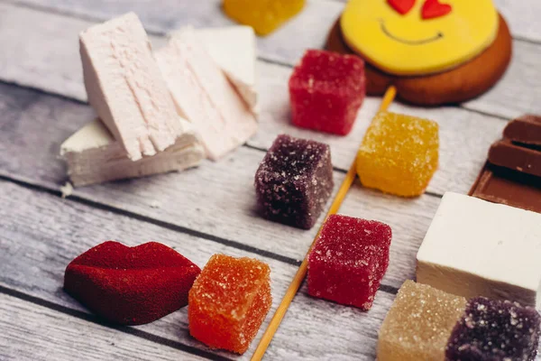 gingerbread in the form of a smiley on a stick marmalade sweets dessert enjoyment wooden background