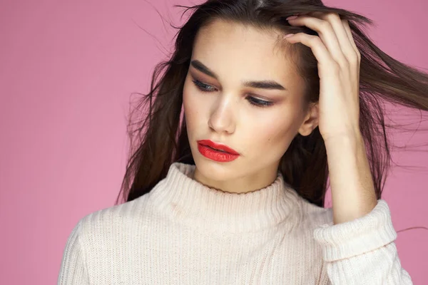 Beautiful brunette red lips white blouse close-up attractive view pink background